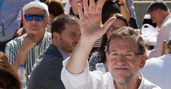 Mariano Rajoy saluda bajo una bandera de Cataluña y España en Badalona