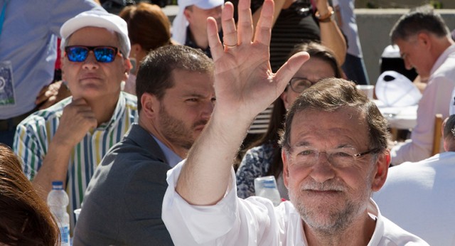 Mariano Rajoy saluda bajo una bandera de Cataluña y España en Badalona